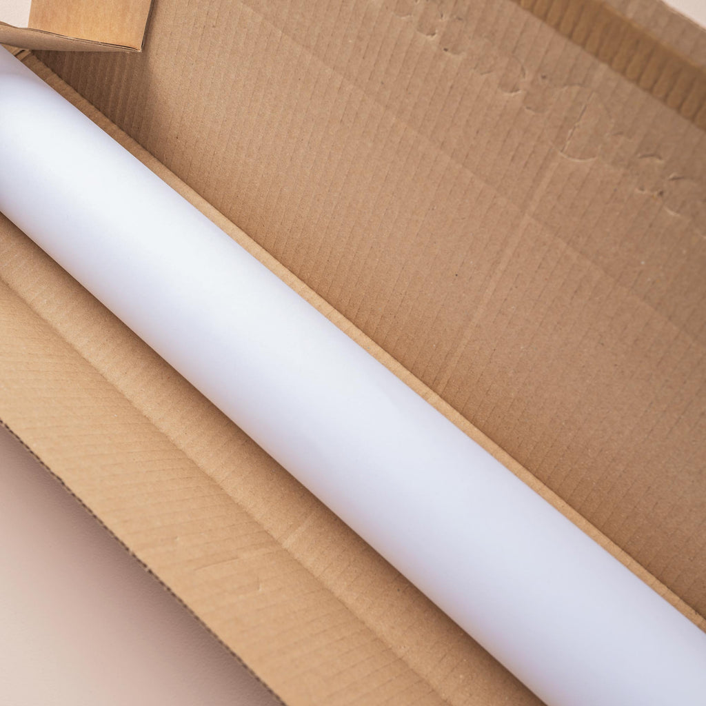 Good Tuesday's Wall planner rolled up in plastic free packaging.