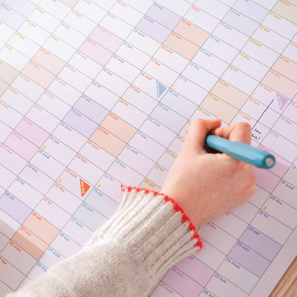 Close-up of date grid with soft tones and recycled paper texture