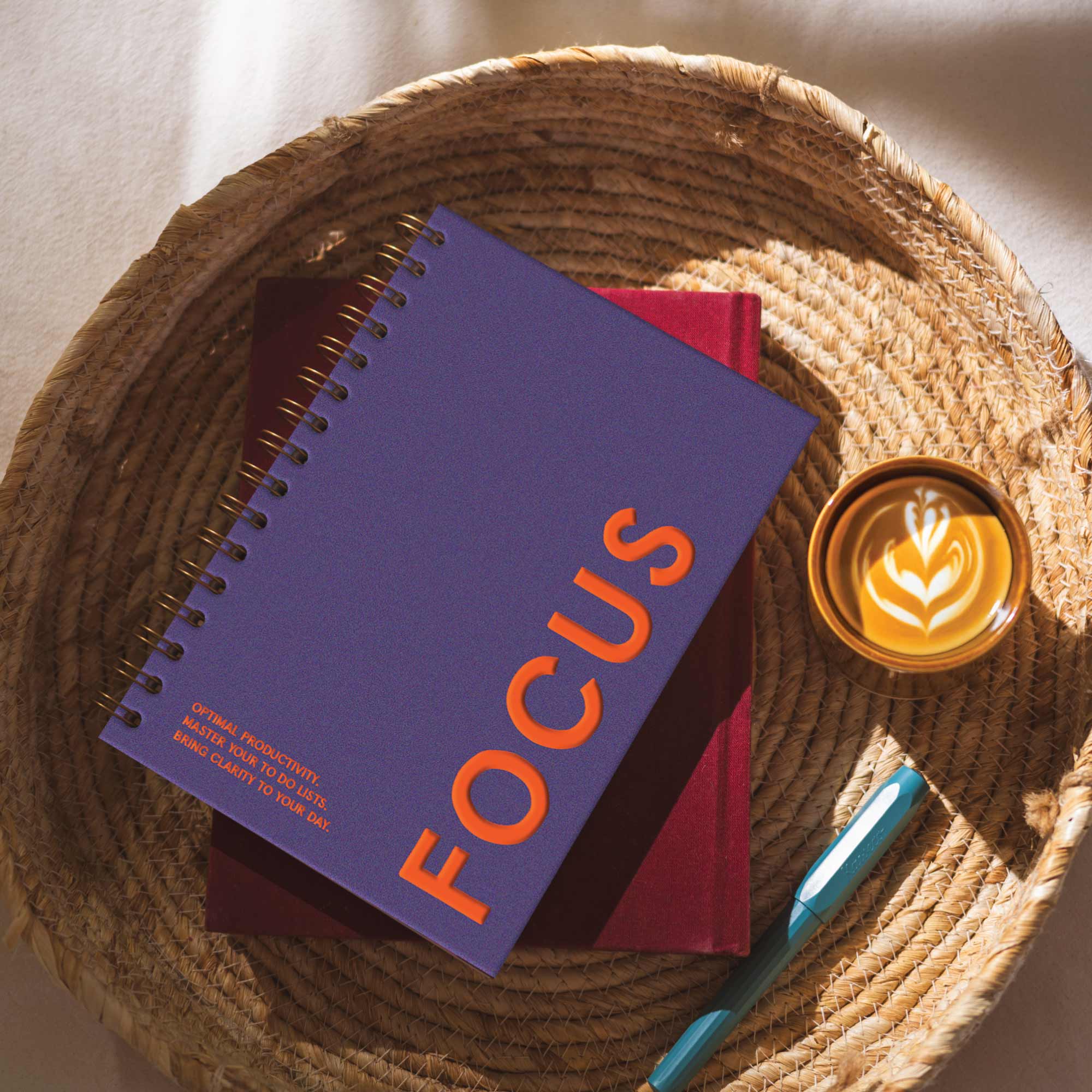 A productivity daily planner from Good Tuesday with a deep rich purple cover and orange writing