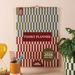 Family planner with checkered design on a wall, with a grid for 2026 - boho aesthetic