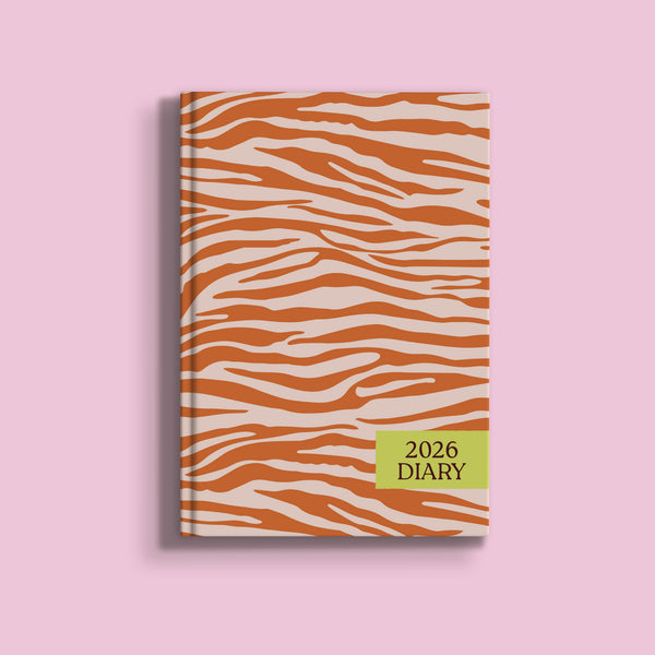 A light beige A5 diary cover for 2026, featuring a bold, abstract zebra stripe pattern in a vibrant orange-brown color. A rectangular lime green box on the bottom right says "2026 DIARY" in black text.