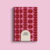 A pink A5 diary cover for 2026, featuring a geometric pattern of dark red circles and half-circles. A large, light beige arch-shaped section at the bottom center of the cover displays the text "2026 DIARY" in dark red.