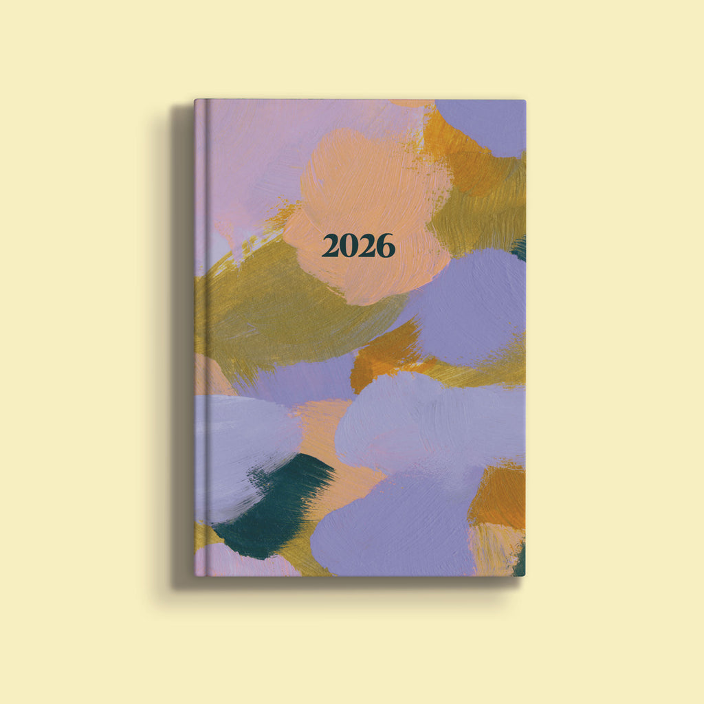 A vibrant A5 diary cover for 2026, featuring an abstract painting with broad, soft brushstrokes in shades of purple, light orange, golden yellow, and dark green. The year "2026" is printed in black text near the top center.