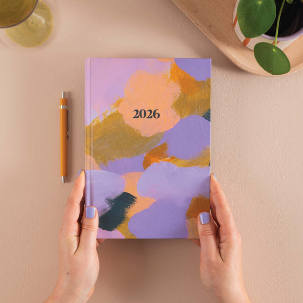 2026 planner with abstract design. Lilac, orange and yellow brush strokes. 