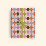 Good Tuesday's eye-catching Harlequin recycled wrapping paper, beautifully displayed as eco-friendly gift wrap, designed and proudly made in the UK.