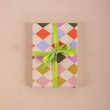 Good Tuesday's eye-catching Harlequin recycled wrapping paper, beautifully displayed as eco-friendly gift wrap, designed and proudly made in the UK.