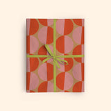 Good Tuesday's Peach Sunsets recycled wrapping paper, beautifully displayed as eco-friendly gift wrap, designed and made in the UK for sustainable gifting.