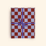 Good Tuesday's new Tidal Berry Check recycled wrapping paper, beautifully displayed as eco-friendly gift wrap, designed and made in the UK for mindful giving.