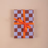 Good Tuesday's eye-catching Tidal Berry recycled wrapping paper, beautifully displayed as eco-friendly gift wrap, designed and proudly made in the UK.