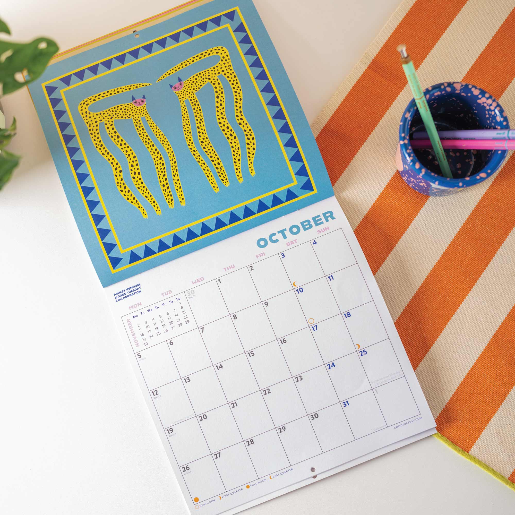 2026 bright and colourful Calendar with a Cat artwork by the artist Ashley. Showing the month of October. 