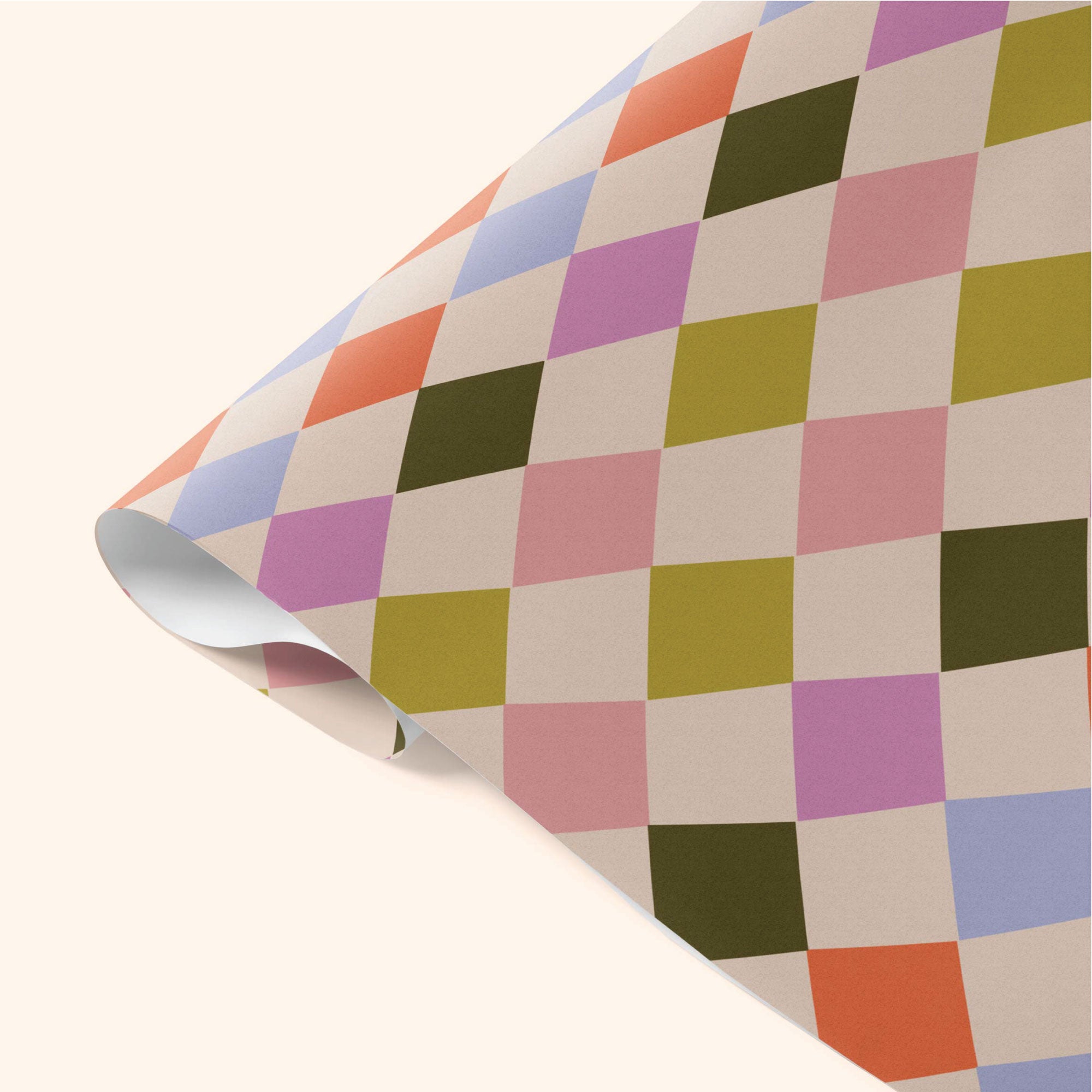 Close-up detail of Good Tuesday's Harlequin wrapping paper, showcasing the intricate geometric pattern and vibrant colors on our sustainable gift wrap.