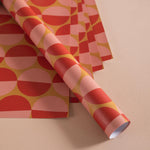 Good Tuesday's eye-catching Peach Sunset recycled wrapping paper, beautifully displayed as eco-friendly gift wrap, designed and proudly made in the UK.