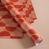 Good Tuesday's eye-catching Peach Sunset recycled wrapping paper, beautifully displayed as eco-friendly gift wrap, designed and proudly made in the UK.