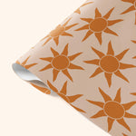 Close-up detail of Good Tuesday's Sunbeam wrapping paper, showcasing the intricate, radiant pattern and smooth finish on our sustainable gift wrap.