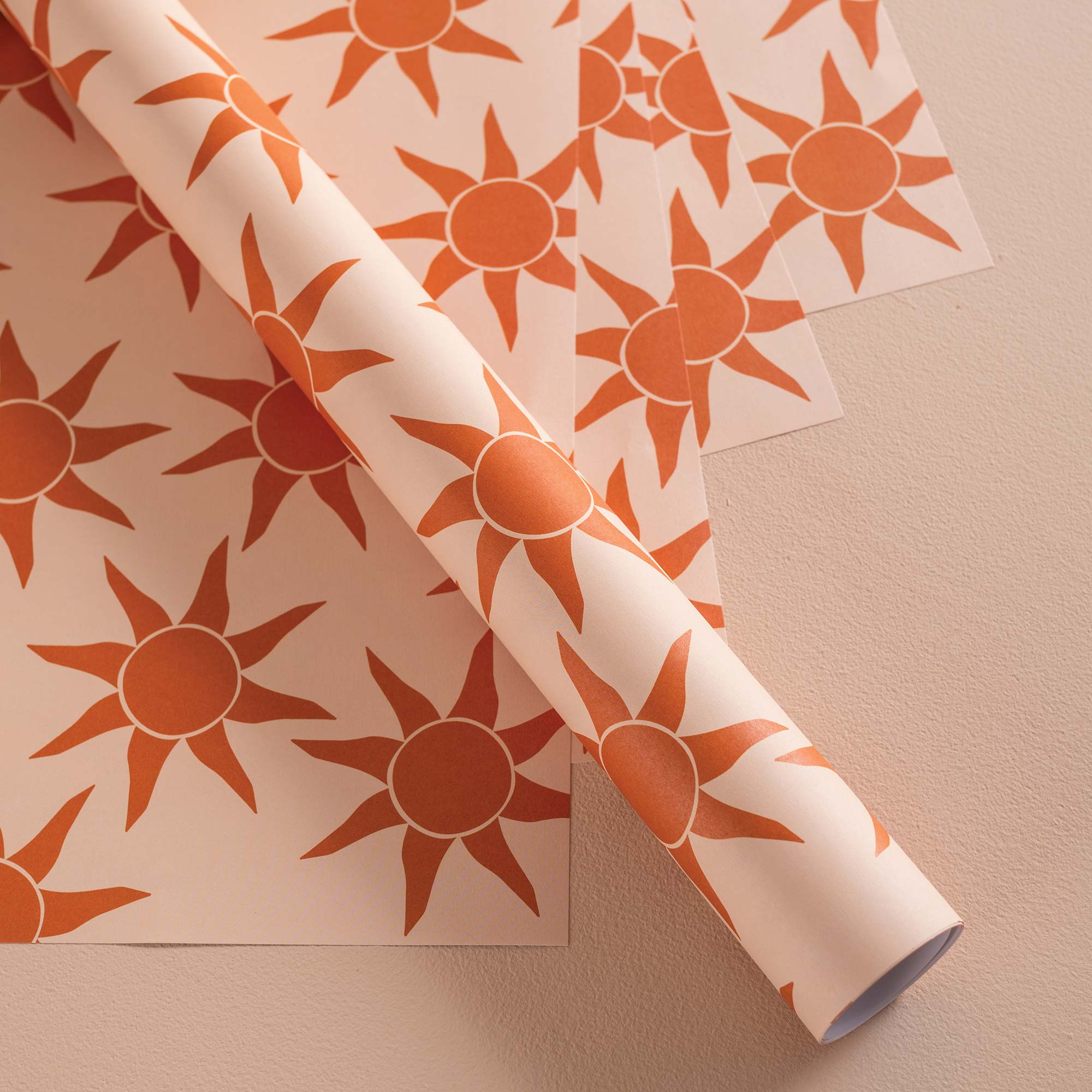 Good Tuesday's vibrant Sunbeam recycled wrapping paper, beautifully displayed as eco-friendly gift wrap, designed and proudly made in the UK.