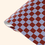 Close-up detail of Good Tuesday's Tidal Berry Check wrapping paper, showcasing the intricate pattern and rich berry tones on our sustainable gift wrap.