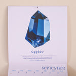 Calendar page with a blue sapphire gemstone and September.