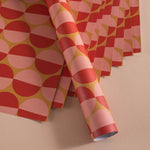 Good Tuesday's eye-catching Peach Sunset recycled wrapping paper, beautifully displayed as eco-friendly gift wrap, designed and proudly made in the UK.