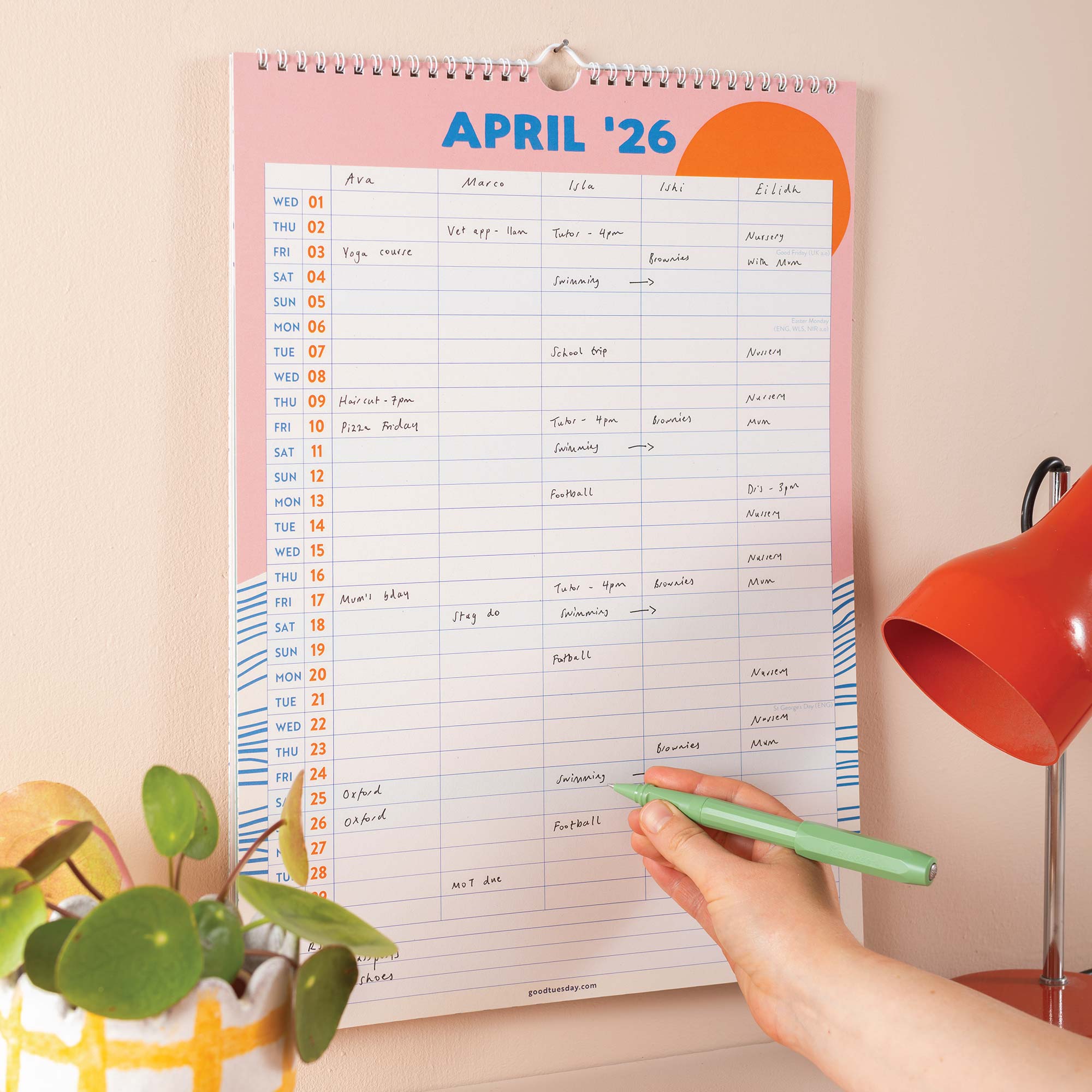Close-up of April 2026 family planner with filled-in appointments