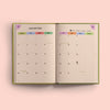 An open 2026 diary showing a detailed calendar view for January. It includes days of the week, dates, and icons for moon phases, along with specific holiday entries like New Year's Day and Burns Night.