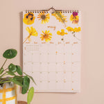 Wall calendar with floral design for May.