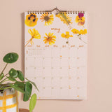 Wall calendar with floral design for May.