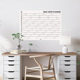 Good Tuesday's Black and White 2026 Yearly planner hanging on a wall. 100% Recycled paper. 
