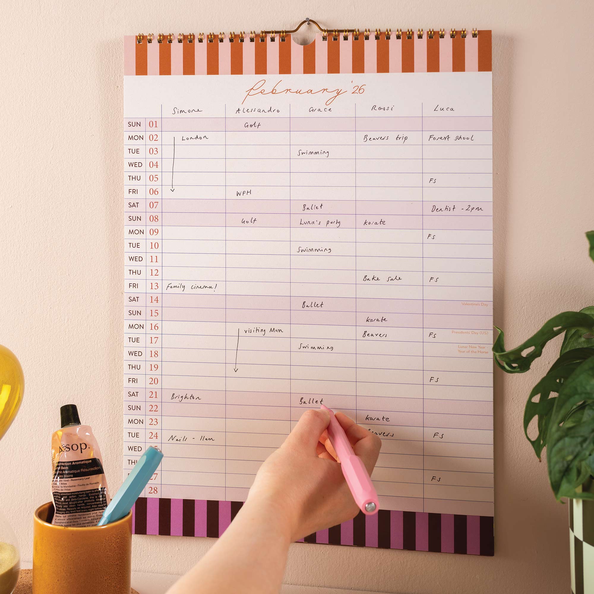Handwriting in 5-column layout of academic family wall calendar