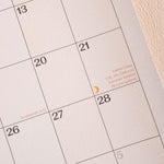 Calendar with dates and holidays marked.
