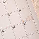 Calendar with dates and holidays marked.
