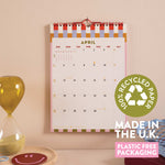 Wall calendar with a checkered design, showing April.