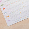 2027 Calendar sheet with colorful month labels. Wall planner made on recycled paper.