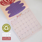 Calendar with a plant design, featuring recycled paper and plastic-free packaging text.