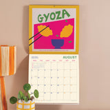 Wall calendar showing UK and US holidays week numbers and moon phases