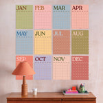 Large A3 undated monthly wall planner in boho scandi colours with 12 separate monthly pages, showing 12 monthly pages arranged together on the wall.