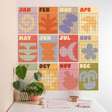 Colorful calendar wall art with geometric designs on a white wall.