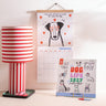 2027 Dog Life wall calendar with playful canine illustrations hanging on wall
