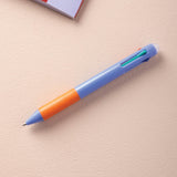 A multiclick turquoise pen with a purple rubber grip