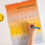 Good Tuesday's 2026 calendar with colorful gradient design. 100% recycled paper.