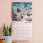 2026 Good Tuesday calendar with a scenic beach and sea image, and uplifting quote 