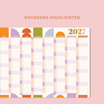 Compact geometric citrus splash wall planner for 2027 with weekends highlighted on a pink background