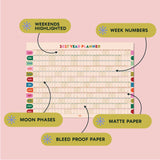 2027 Good Tuesday Wall planner with highlighted weekends, week numbers, moon phases, and bleed-proof paper on a pink background.