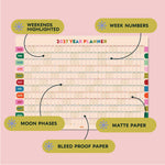 2027 Good Tuesday Wall planner with highlighted weekends, week numbers, moon phases, and bleed-proof paper on a pink background.