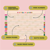 2027 Good Tuesday Wall planner with highlighted weekends, week numbers, moon phases, and bleed-proof paper on a pink background.