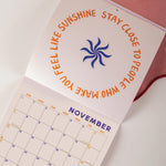 Positive artwork, calendar laid open on a november page. 