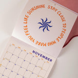 Positive artwork, calendar laid open on a november page. 