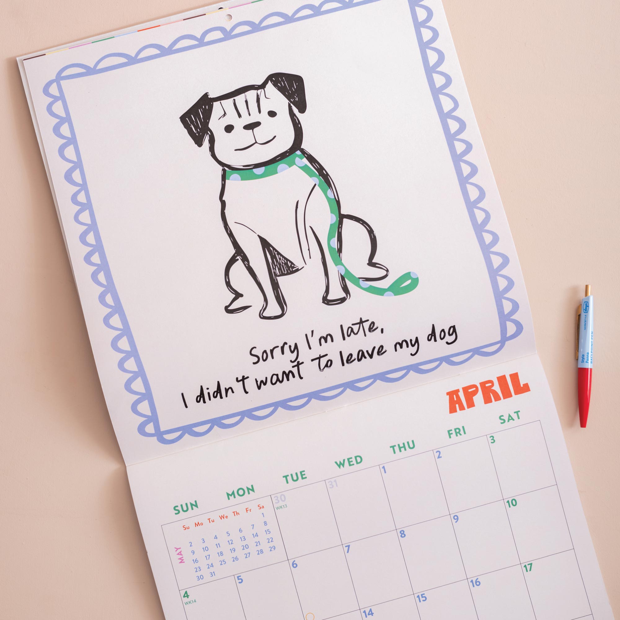 Month to view page of 2027 Dog Life calendar showing large date grid and dog artwork