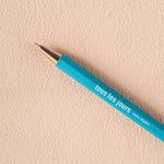 A vivid turquoise refillable ballpoint pen with a metal tip