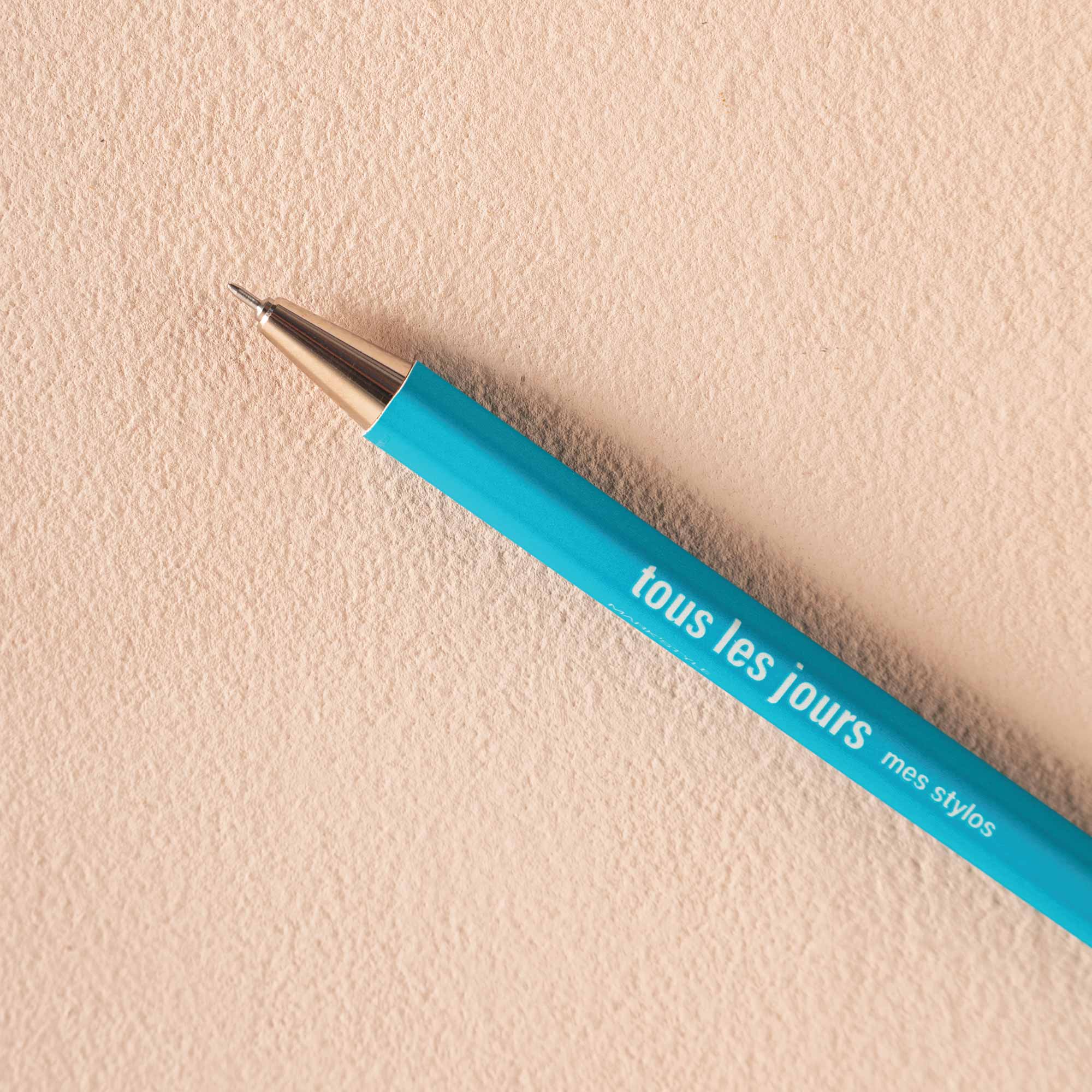 A vivid turquoise refillable ballpoint pen with a metal tip
