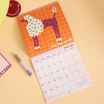 Arty Dogs wall calendar, month to view grid with playful dog illustrations